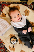 bébé sur nid friends avec clochette et bavoir latte